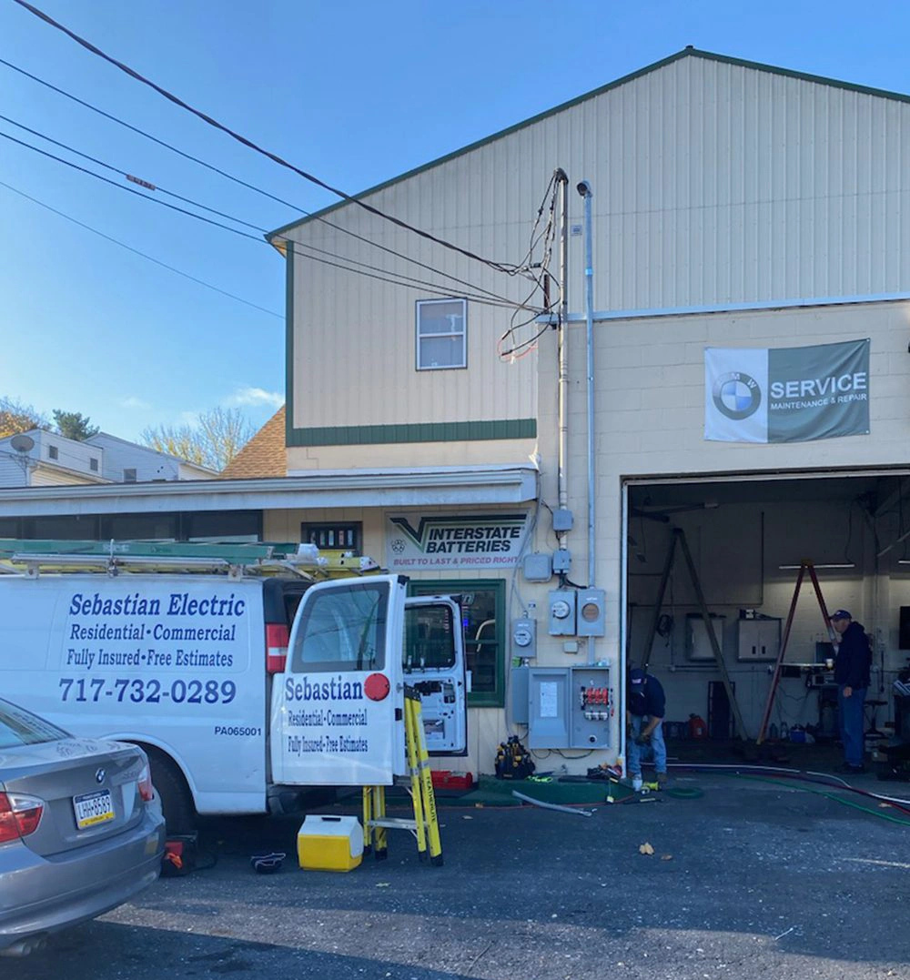 Sebastian electric car parked in front of a garage
